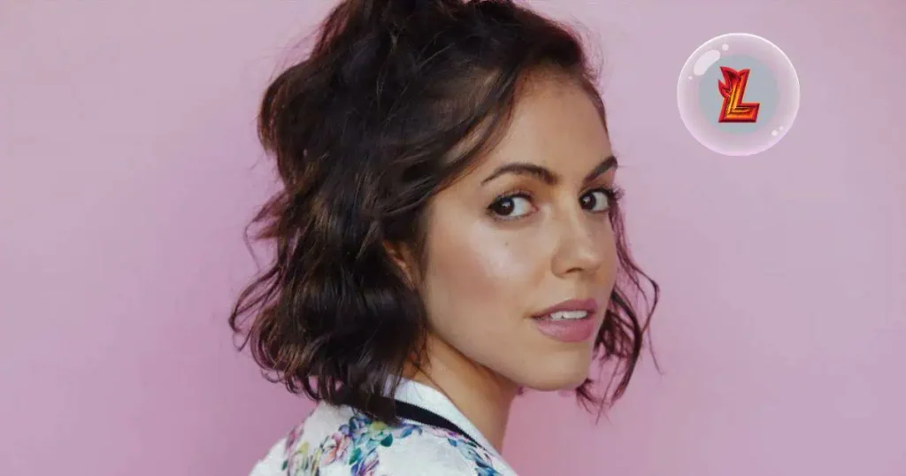 A woman named Kathryn Feeney with short hair, wearing a vibrant floral top, exudes confidence and style.