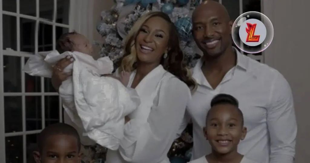 Melody Holt family poses together, smiling joyfully with their baby in a heartwarming family photo.